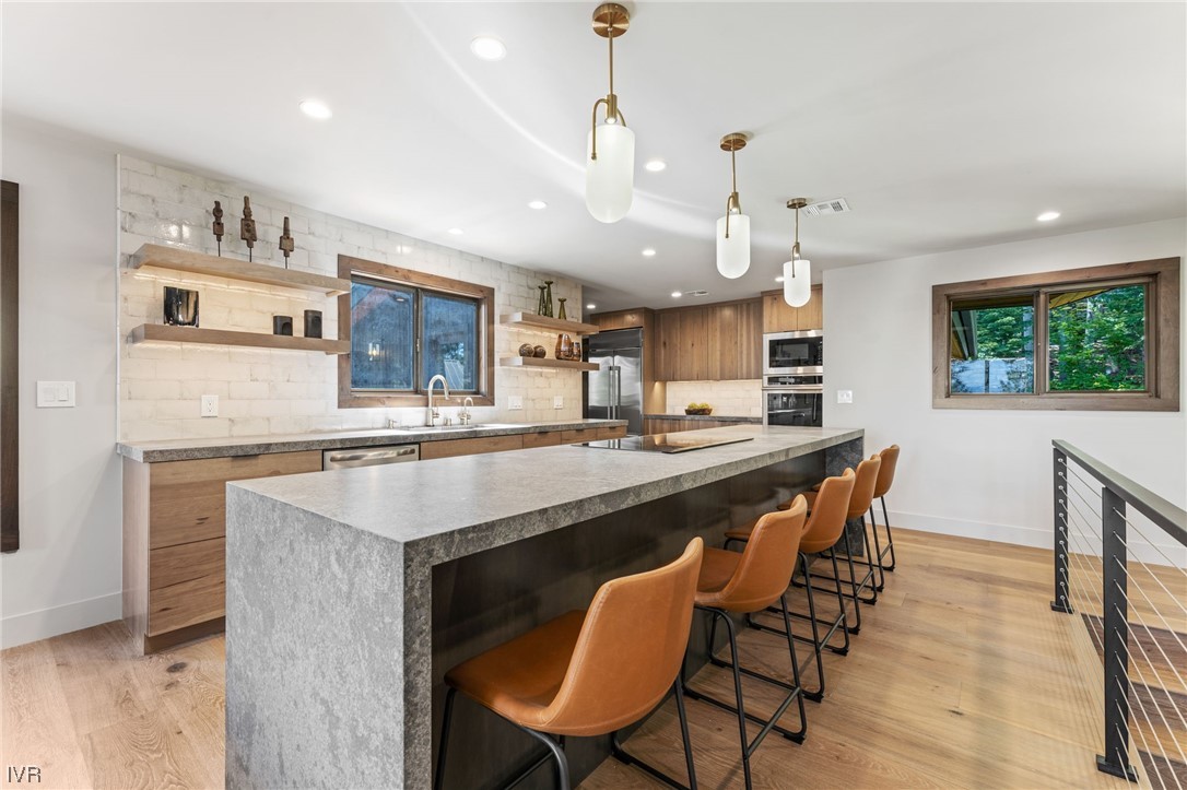 859 Tyner Way Incline Village, NV 89451 - Photo 11 of 33 a kitchen with stainless steel appliances granite countertop a kitchen island a stove a table and chairs in it