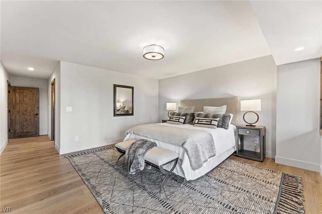 859 Tyner Way Incline Village, NV 89451 - Photo 20 of 33 a bedroom with a bed and a lamp with wooden floor