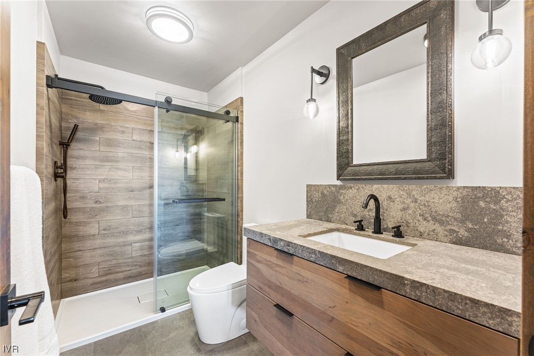 859 Tyner Way Incline Village, NV 89451 - Photo 24 of 33 a bathroom with a granite countertop sink toilet and shower