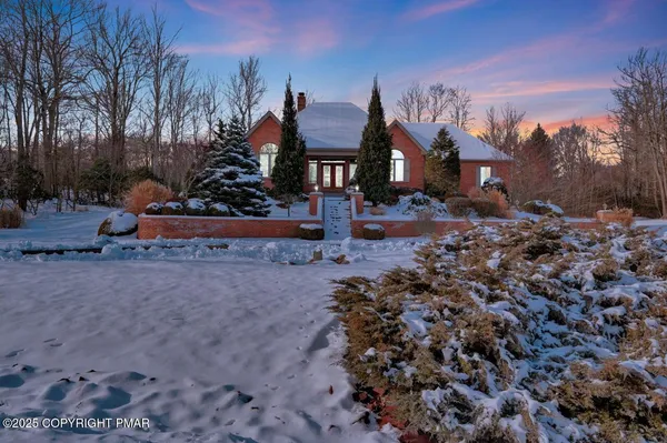 a view of a street with a house in the background