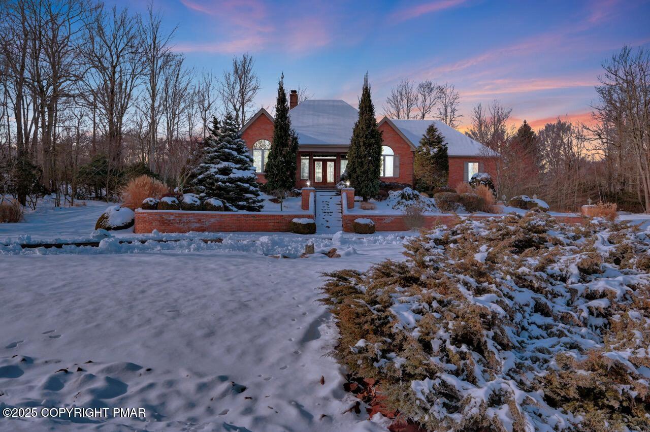 a view of a street with a house in the background