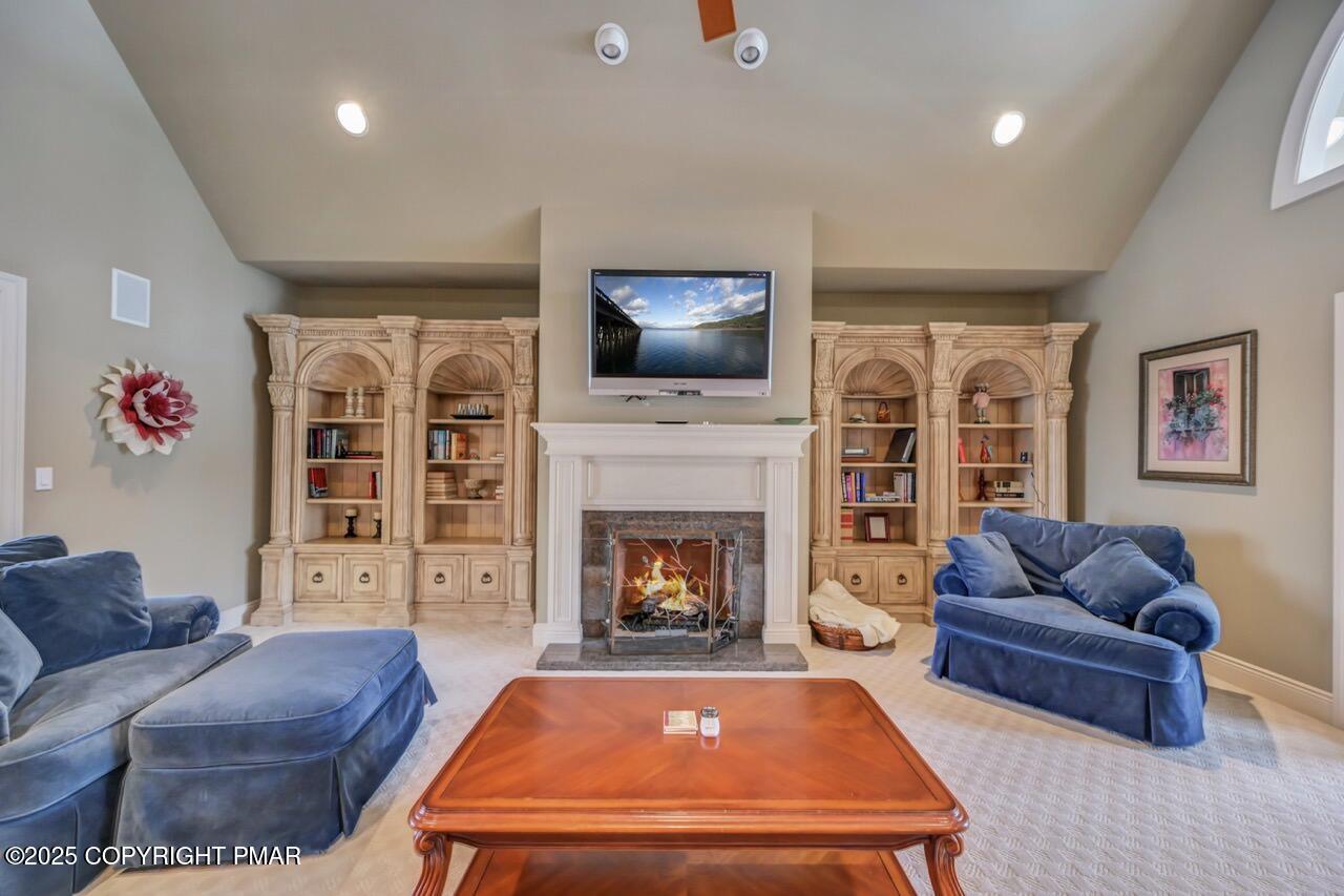 235 Wolf Hollow Road Lake Harmony, PA 18624 - Photo 19 of 96 a living room with furniture a flat screen tv and a fireplace