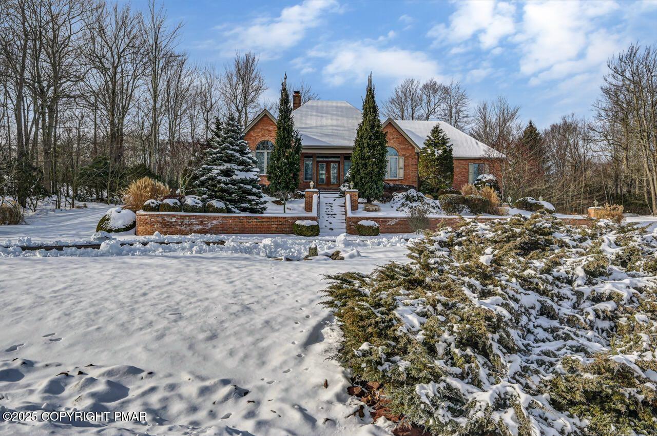 235 Wolf Hollow Road Lake Harmony, PA 18624 - Photo 2 of 96 a front view of a house with a yard and trees