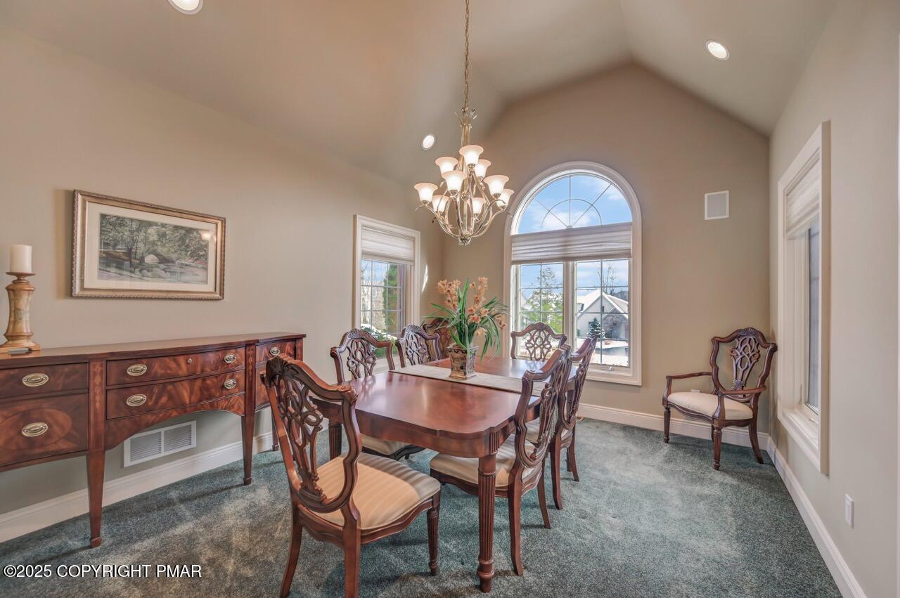 235 Wolf Hollow Road Lake Harmony, PA 18624 - Photo 37 of 98 a view of a dining room with furniture and a chandelier