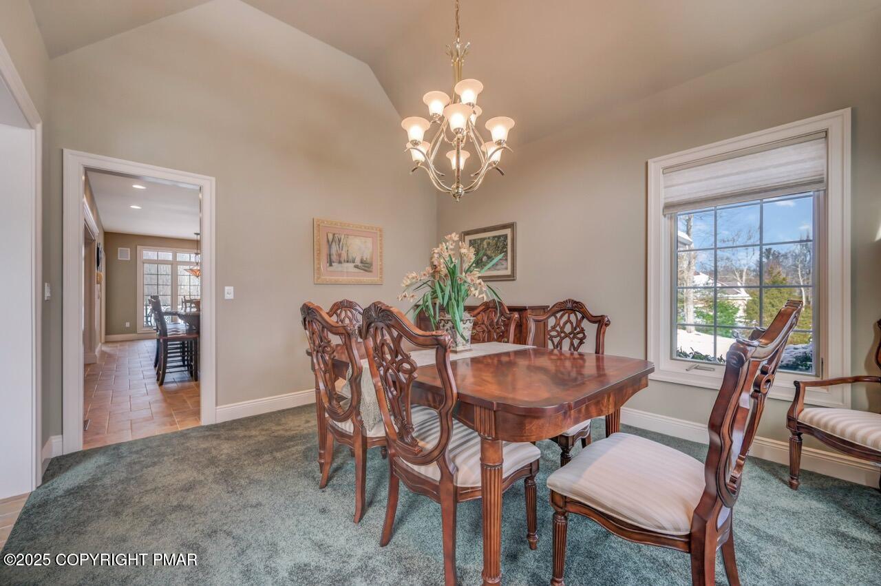 235 Wolf Hollow Road Lake Harmony, PA 18624 - Photo 41 of 98 a dining room with furniture a chandelier and wooden floor