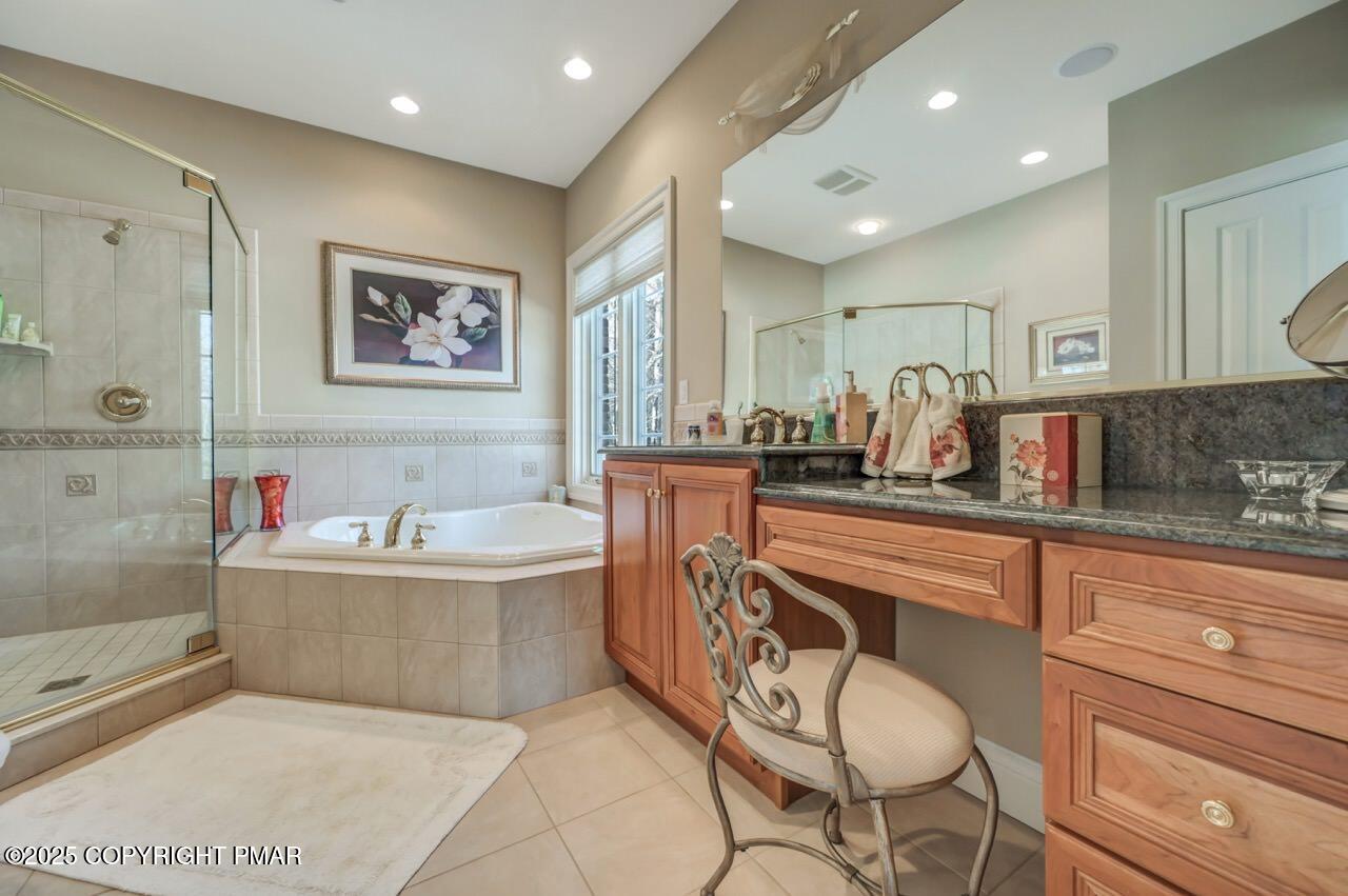 235 Wolf Hollow Road Lake Harmony, PA 18624 - Photo 55 of 96 a spacious bathroom with a tub sink and mirror