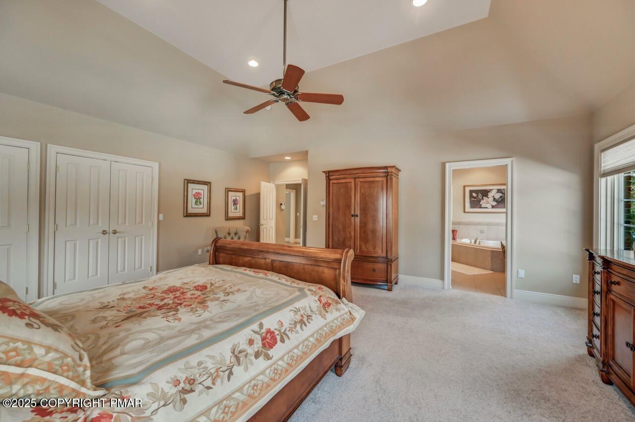 235 Wolf Hollow Road Lake Harmony, PA 18624 - Photo 55 of 98 a bedroom with a large bed and a chandelier