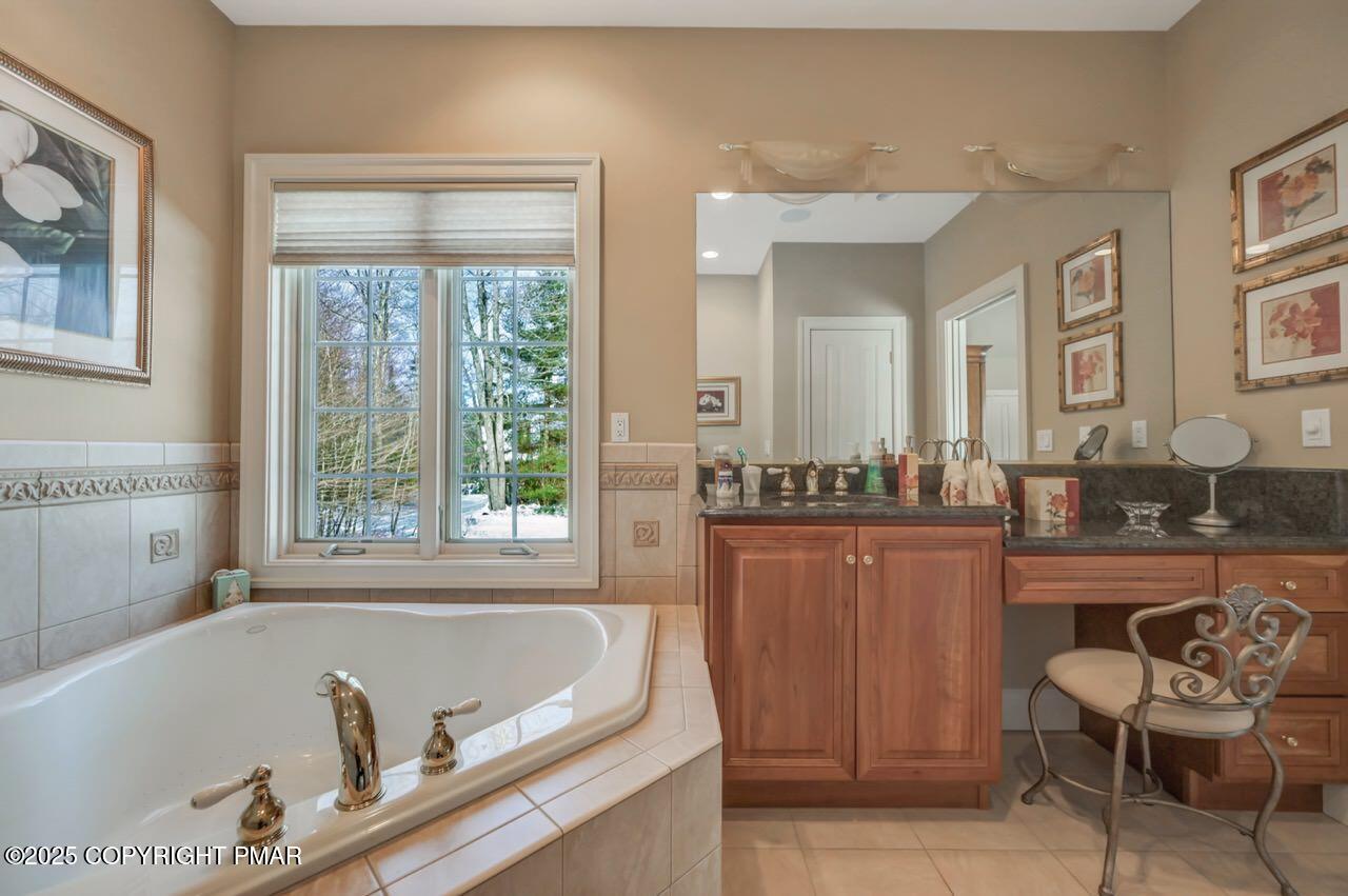 235 Wolf Hollow Road Lake Harmony, PA 18624 - Photo 56 of 96 a bath tub sitting in a bathroom next to a window