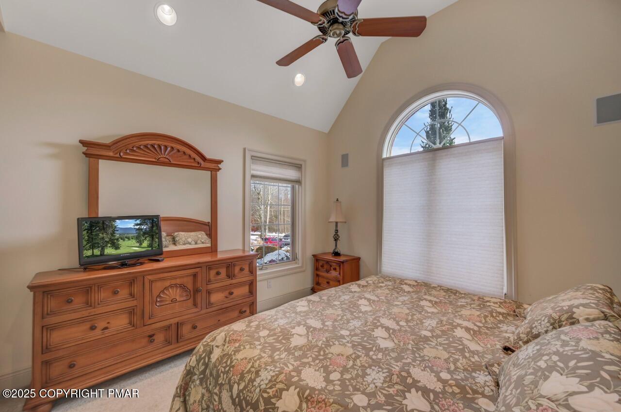 235 Wolf Hollow Road Lake Harmony, PA 18624 - Photo 60 of 98 a bedroom with a bed and a flat tv screen on dresser