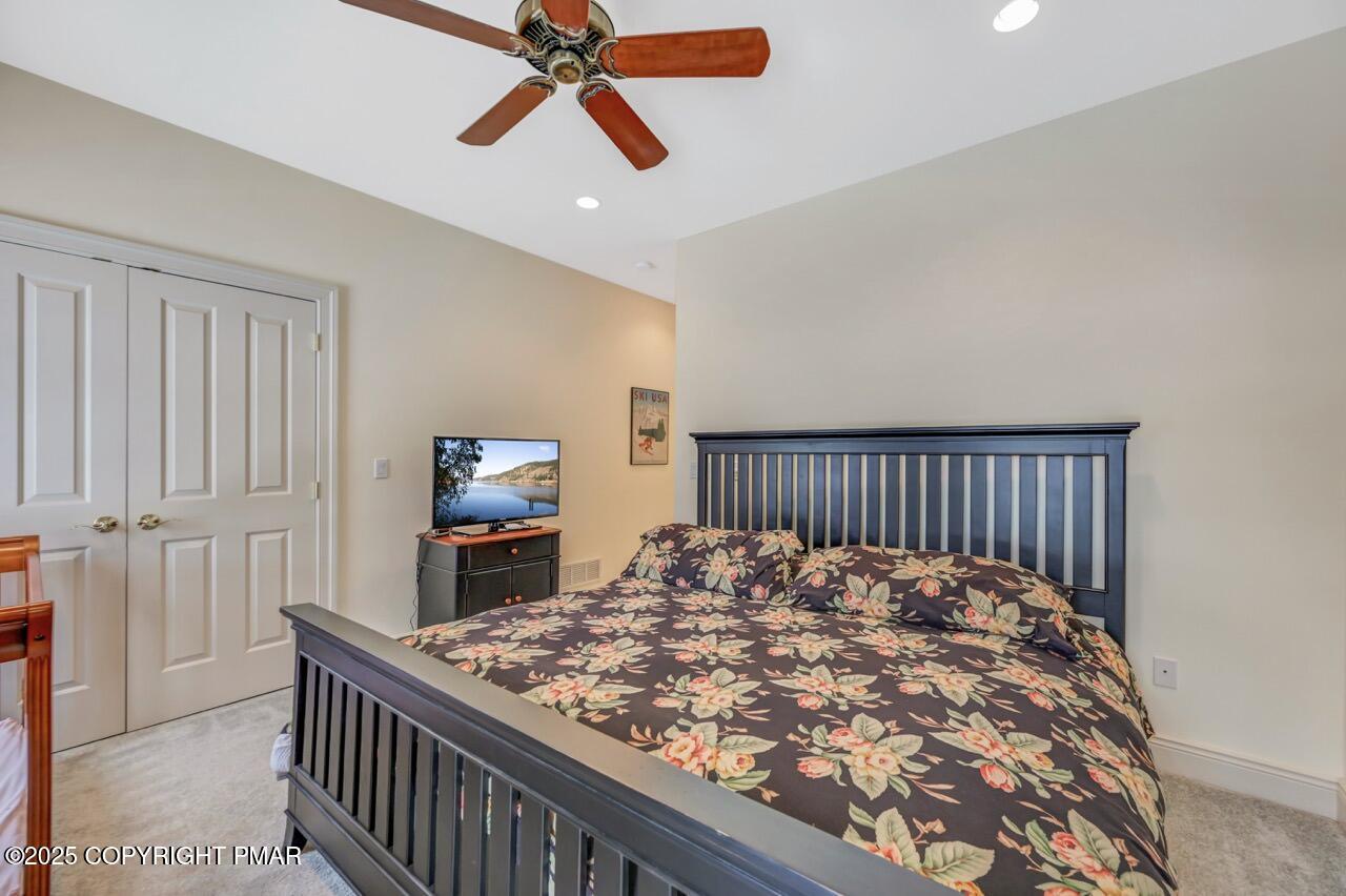 235 Wolf Hollow Road Lake Harmony, PA 18624 - Photo 69 of 96 a bedroom with a bed and a chandelier