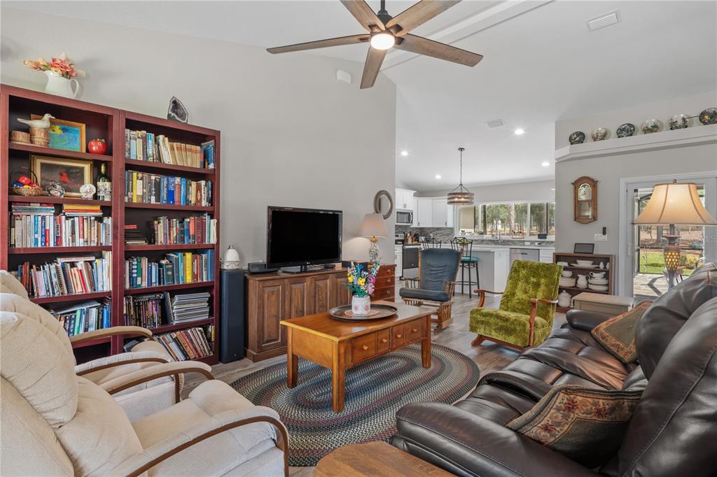 12929 Southwest 89th Street Dunnellon, FL 34432 - Photo 10 of 76 a living room with furniture a rug and a book shelf