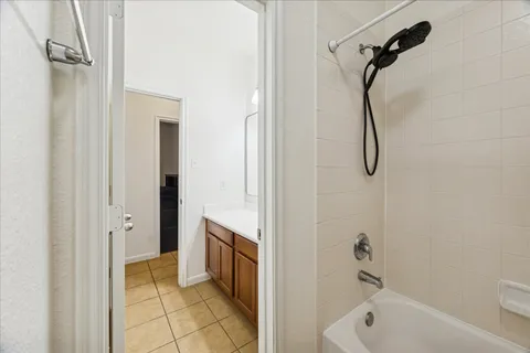 a bathroom with a tub a sink a mirror and a shower