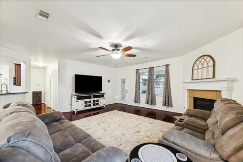 a living room with furniture flat screen tv and a fireplace