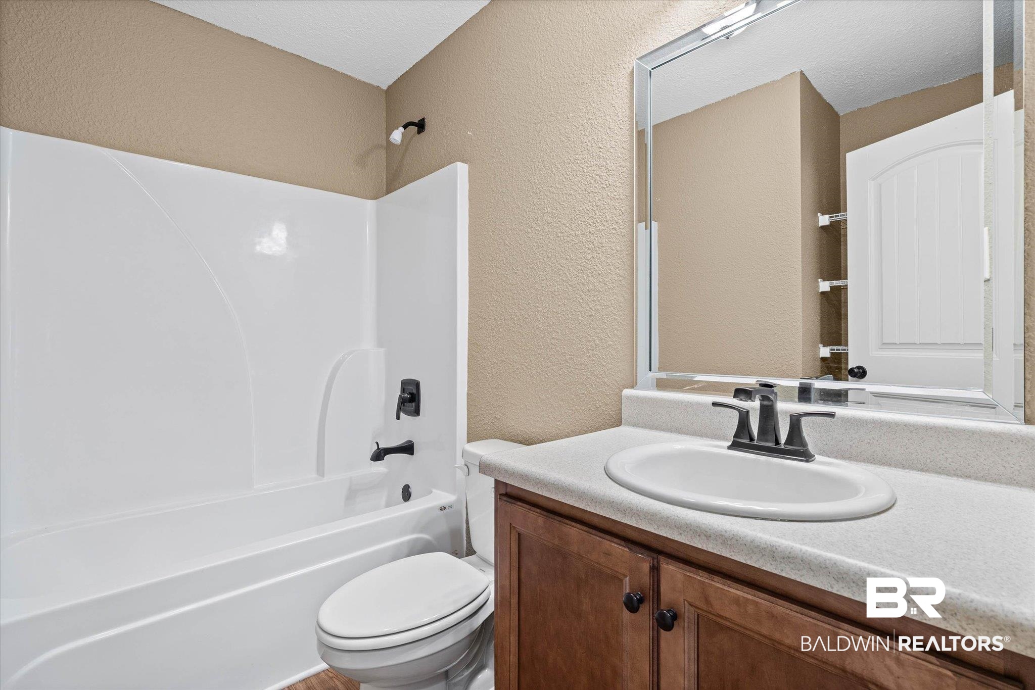 101 Washington Boulevard Foley, AL 36535 - Photo 19 of 32 Full bath with a textured wall, vanity, and washtub / shower combination