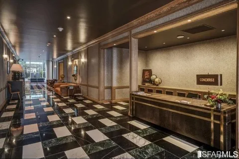 a kitchen with a checkered floor and white cabinets