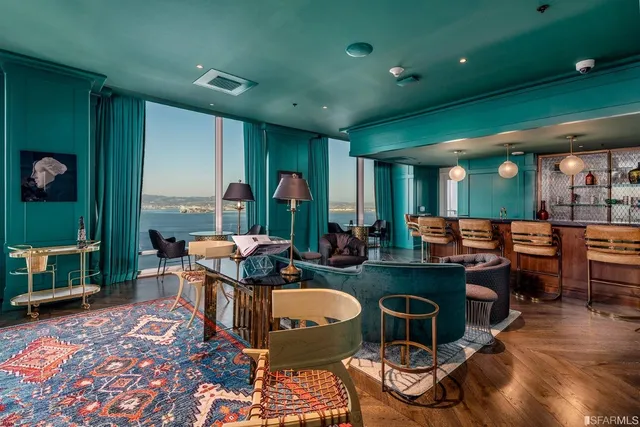 a living room with furniture a rug and a large window