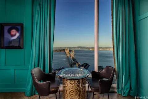 a view of a balcony with furniture and a potted plant