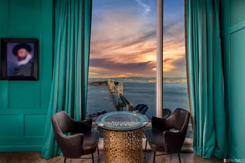 a view of a balcony with furniture and a potted plant