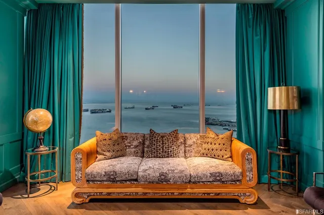 a living room with furniture and a lamp