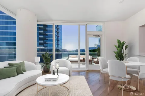 a living room with furniture potted plant and a large window