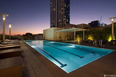 a view of a balcony with floor to ceiling windows and a basket ball poll
