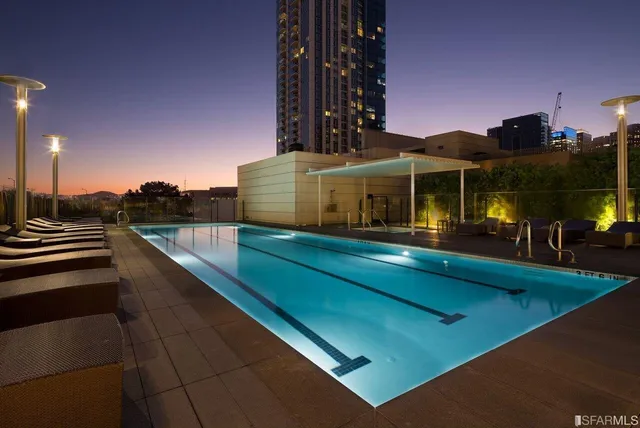 a view of a balcony with floor to ceiling windows and a basket ball poll