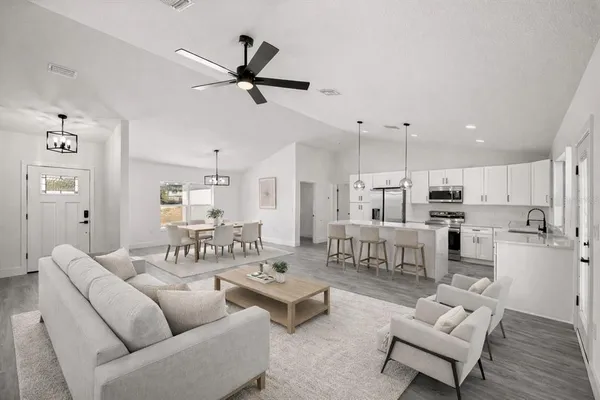 a living room with furniture and kitchen view