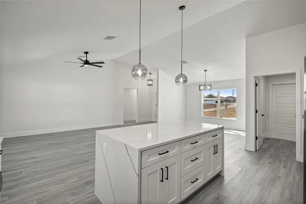a spacious bathroom with a granite countertop sink a mirror and shower view
