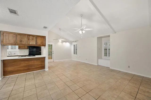 a kitchen with stainless steel appliances a stove and white cabinets