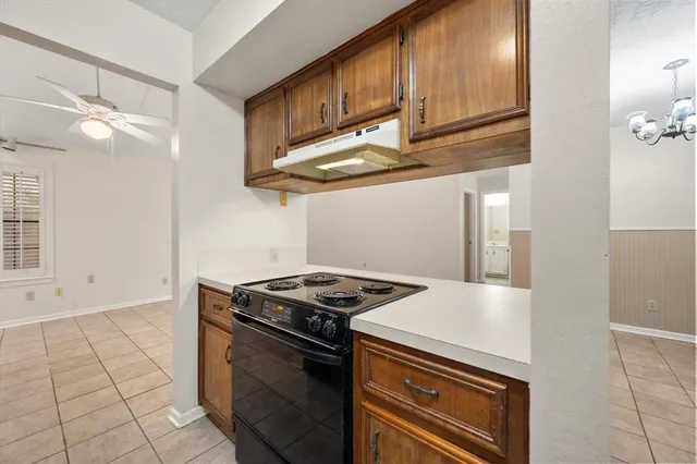 a kitchen with stainless steel appliances granite countertop a stove and a refrigerator