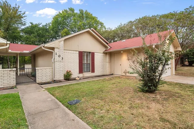 a view of a house with a yard and garage