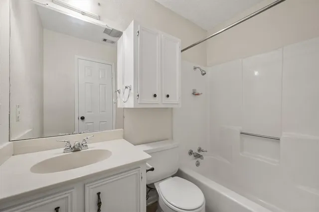 a view of a big room with wooden floor and windows