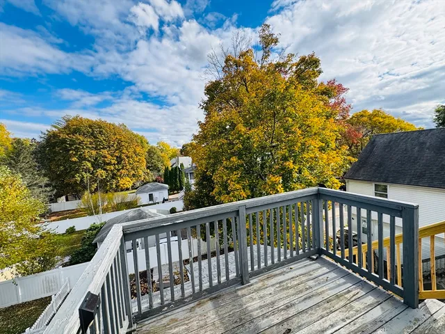 a view of balcony with wooden floor and fence