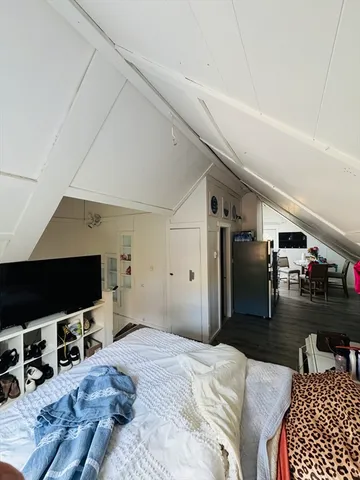 a bedroom with furniture and a flat screen tv