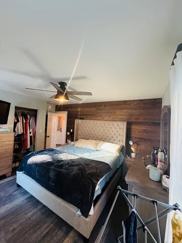 a bedroom with furniture and wooden floor