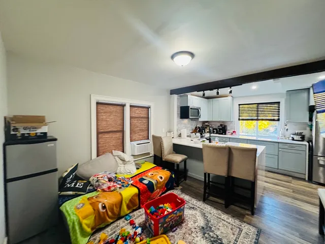 a bed room with furniture and a baby crib