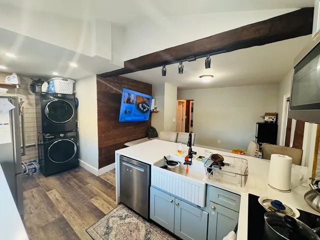 a kitchen with stainless steel appliances granite countertop a refrigerator a sink a stove and cabinets