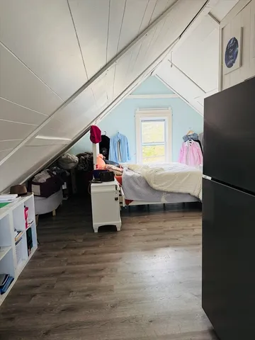 a bedroom with bed and a window