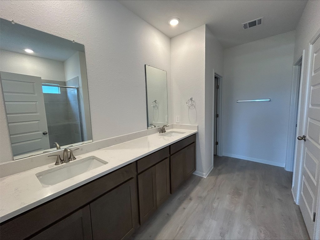 4213 Forel Road Pflugerville, TX 78660 - Photo 9 of 10 a bathroom with a double vanity sink mirror and double