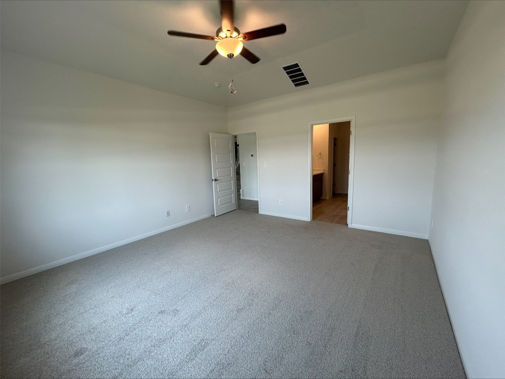 4213 Forel Road Pflugerville, TX 78660 - Photo 10 of 10 an empty room with a ceiling fan and a fan