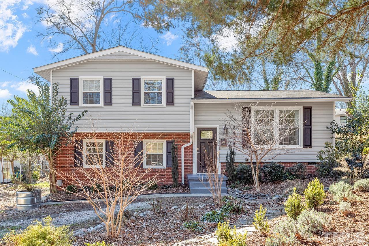 2404 Remington Road Raleigh, NC 27610 - Photo 1 of 33 a front view of a house with garden