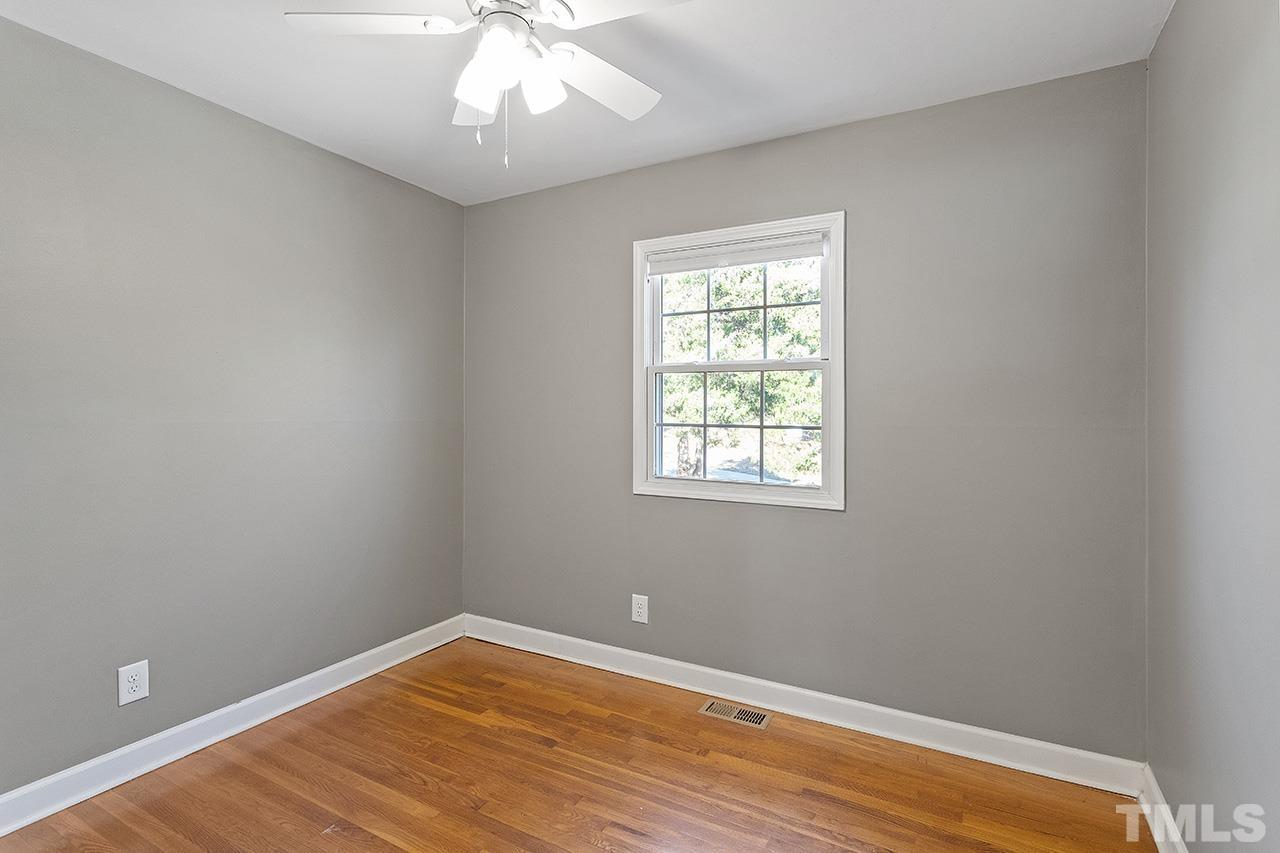 2404 Remington Road Raleigh, NC 27610 - Photo 24 of 33 an empty room with wooden floor and windows