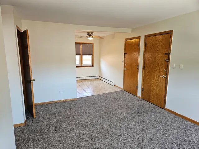 an empty room with windows and closet