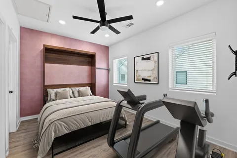 a bedroom with a bed window and a desk