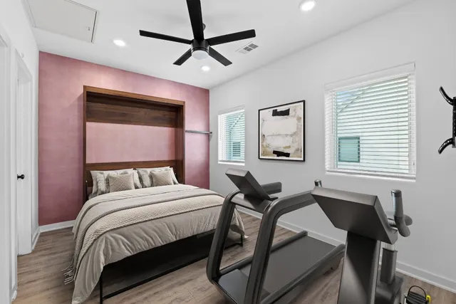 a bedroom with a bed window and a desk