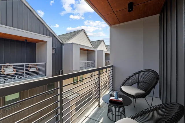 a balcony with table and chairs