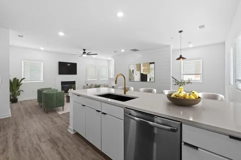 a kitchen with a sink and a stove top oven