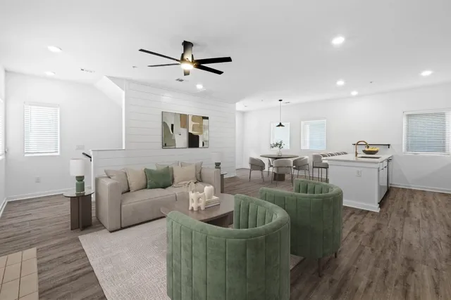 a living room with furniture and kitchen view