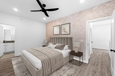 a bedroom with a bed and a chandelier