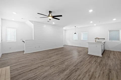 a view of a kitchen with wooden floor and a sink